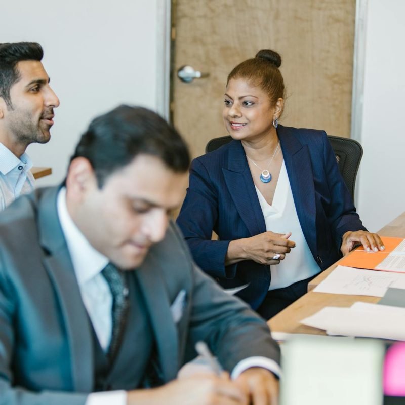 Professional team discussing project ideas in an office setting, featuring diverse employees.